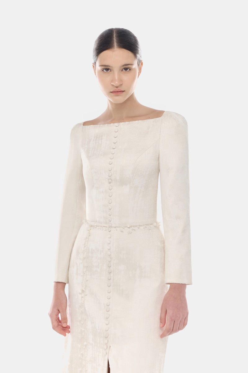Elegant ivory brocade split maxi dress by Montsand featuring intricate fabric details and a flowing silhouette.