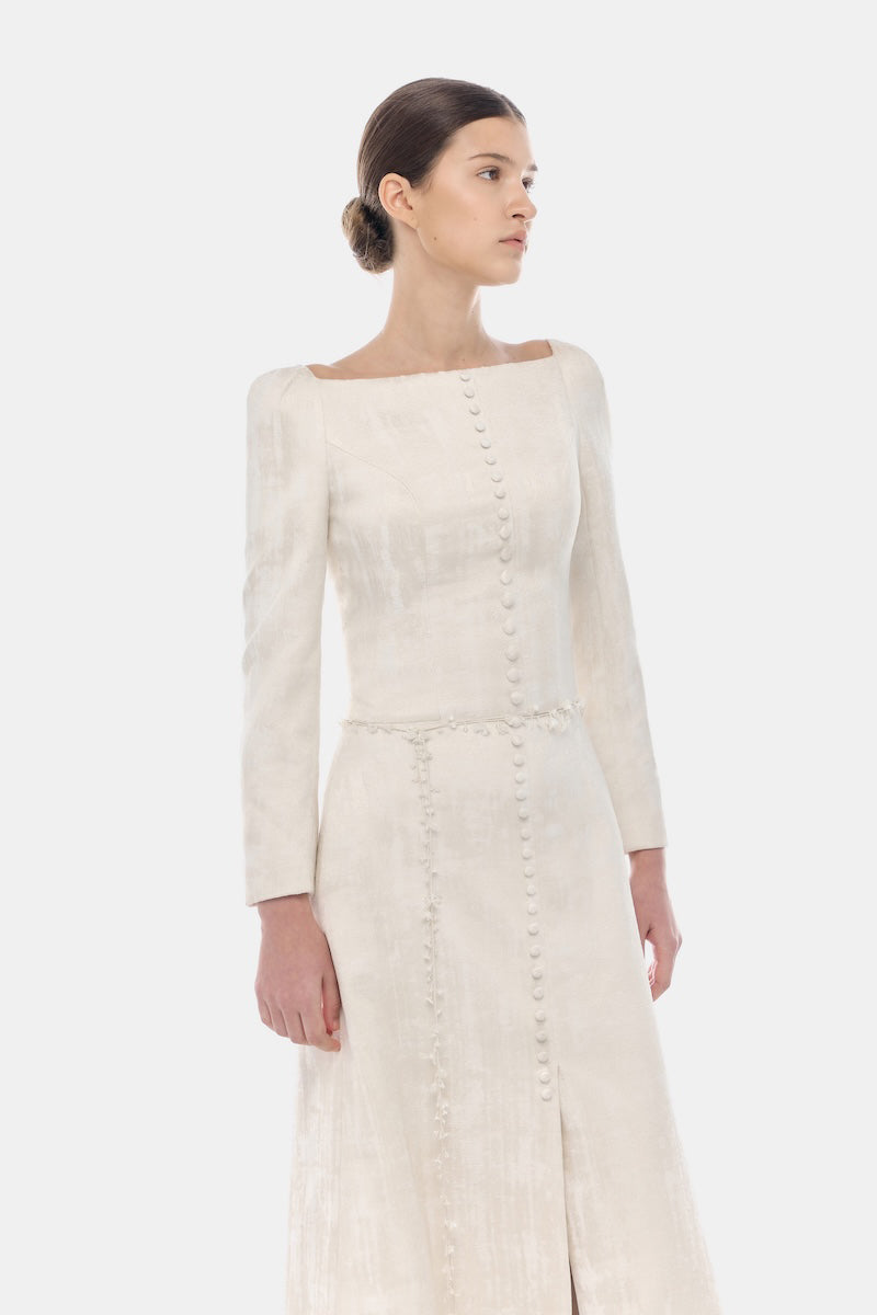 Ivory brocade split maxi dress by Montsand featuring elegant fabric and a flowing silhouette.