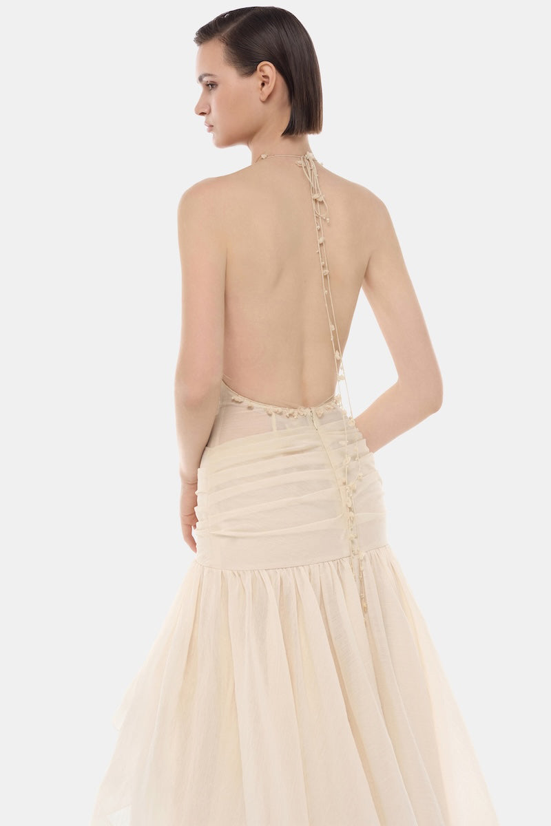 Ivory cut-out halter maxi dress by Montsand featuring a flowing silhouette and stylish back cut-outs.
