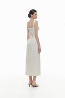 Ivory floral bustier midi dress by Montsand, featuring a fitted bodice, floral pattern, and elegant midi length.