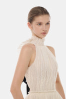 Ivory tiered halter gown by Montsand, floor-length maxi dress with layered fabric and halter neckline, elegant evening wear.