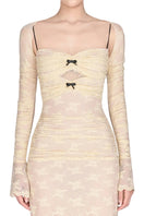 Ivory maxi dress with a bow cut-out design, laces, and a flowing silhouette by Montsand. Perfect for elegant summer occasions.