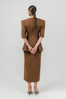 Brown Izakova NEDA midi skirt with a flowy fabric and subtle pleats, styled for a chic and versatile look.
