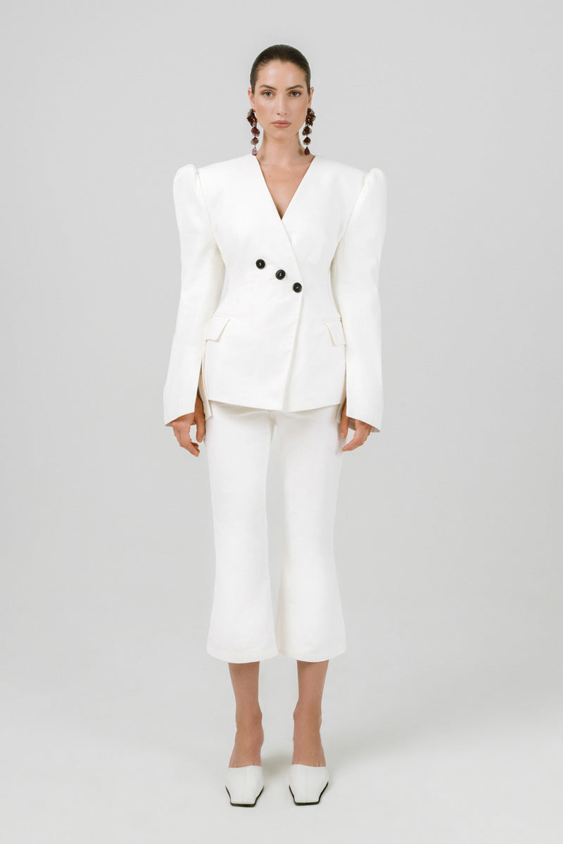 Izakova REA pants in off-white fabric with a relaxed fit, featuring a high waist and wide-leg design.
