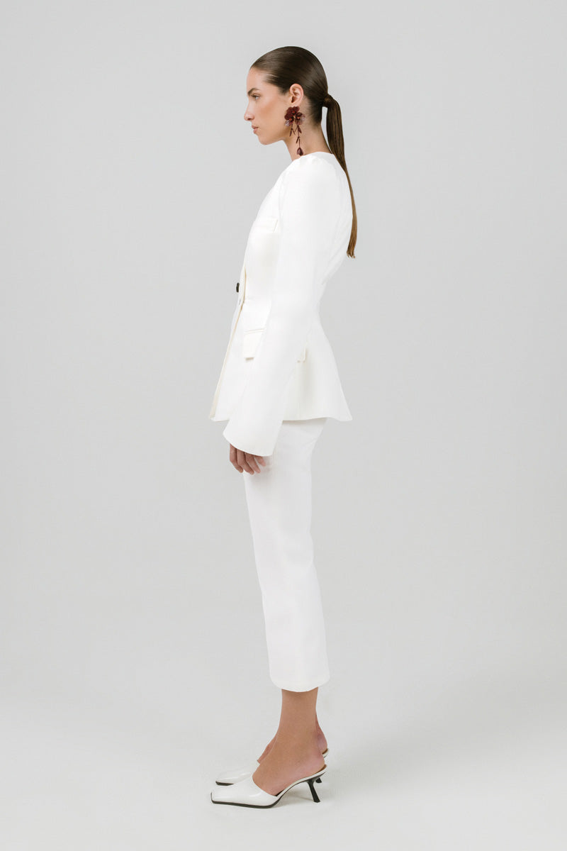 Off-white Izakova Azera blazer displayed on a hanger, showcasing tailored fit and stylish lapels for a sophisticated look.