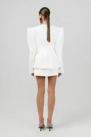 Off-white Izakova Atena mini skirt with a fitted design, shown hanging on a hanger. Stylish and versatile for casual or dressy outfits.