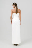 Izakova Dariana off-white maxi dress displayed on a hanger, featuring flowing fabric and elegant design.