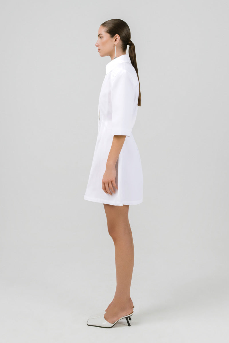 Off-white Franka shirt dress by Izakova, featuring a tailored mini dress with collar and button details, casual and stylish.