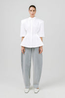 Off-white Izakova EDISA shirt displayed on a hanger, showcasing a stylish, casual shirt with a classic collar and button-front design.