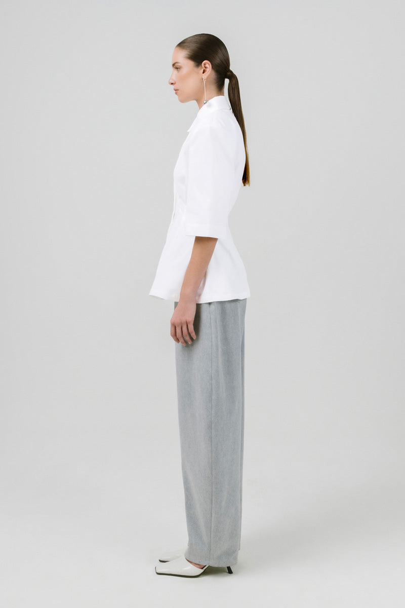 Off-white Izakova EDISA shirt displayed on a hanger, showcasing a stylish, casual long-sleeve shirt with a relaxed fit.