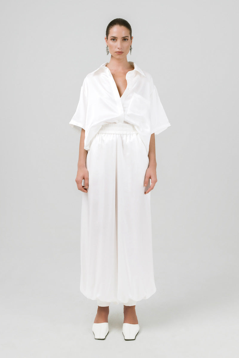 Izakova Marea Pants featuring a relaxed fit with adjustable drawstrings and lightweight fabric, displayed on a hanger.