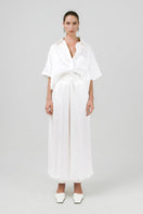 Izakova Marea Pants in neutral fabric, featuring a relaxed fit and stylish design, shown on a model.