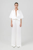 White Melanie pants by Izakova, stylish tailored pants with a slim fit and clean design, shown on a mannequin.