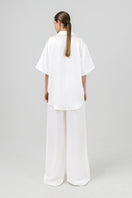 White Melanie pants by Izakova, tailored with a sleek fit and clean design, displayed on a neutral background
