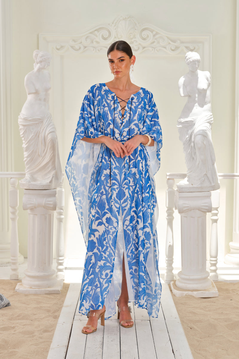 Nana Gotti Izara kaftan maxi dress featuring vibrant floral patterns and flowing fabric, perfect for elegant summer wear.