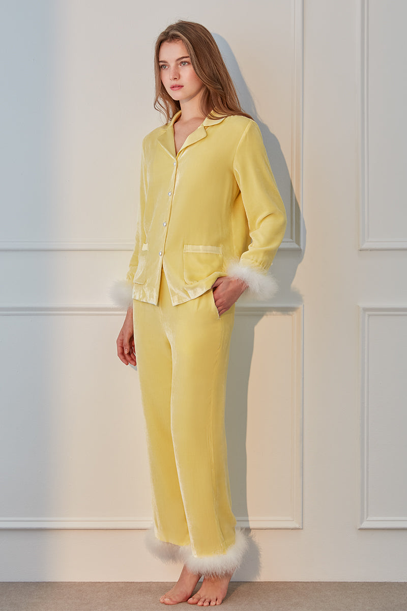 Yellow MANITO DIVA pajama set displayed on a bed, featuring soft fabric and relaxed fit for comfortable sleepwear.