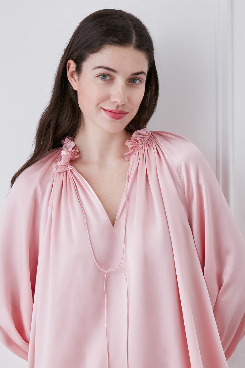 Pink MANITO loungewear set with ruffle-trim blouse and matching shorts displayed on a hanger.