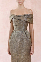 Elegant gold jacquard pleated off-shoulder gown by HACCHIC COUTURE, featuring a flowing silhouette and intricate fabric details.