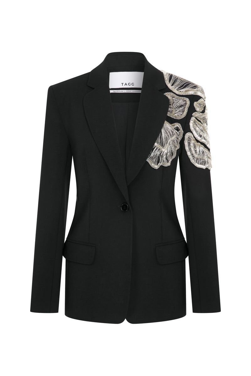 Tagg jacket with intricate hand embroidery, featuring detailed floral patterns on a stylish outerwear piece.