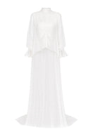 Elegant bridal cape in bambula silk by JC Pajares, showcasing delicate fabric draped over a model for a luxurious cover-up.