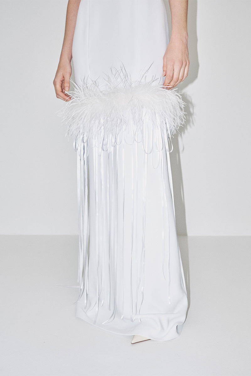 Elegant JC Pajares halter-neck maxi dress with feather embellishments, perfect for formal occasions or bridal looks.
