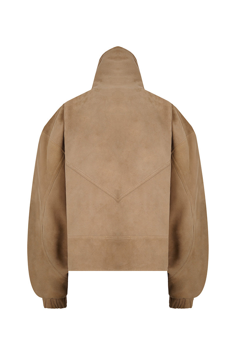 Lorena Saravia Julia suede jacket shown from the back, featuring a stylish design and soft suede material in a natural setting.