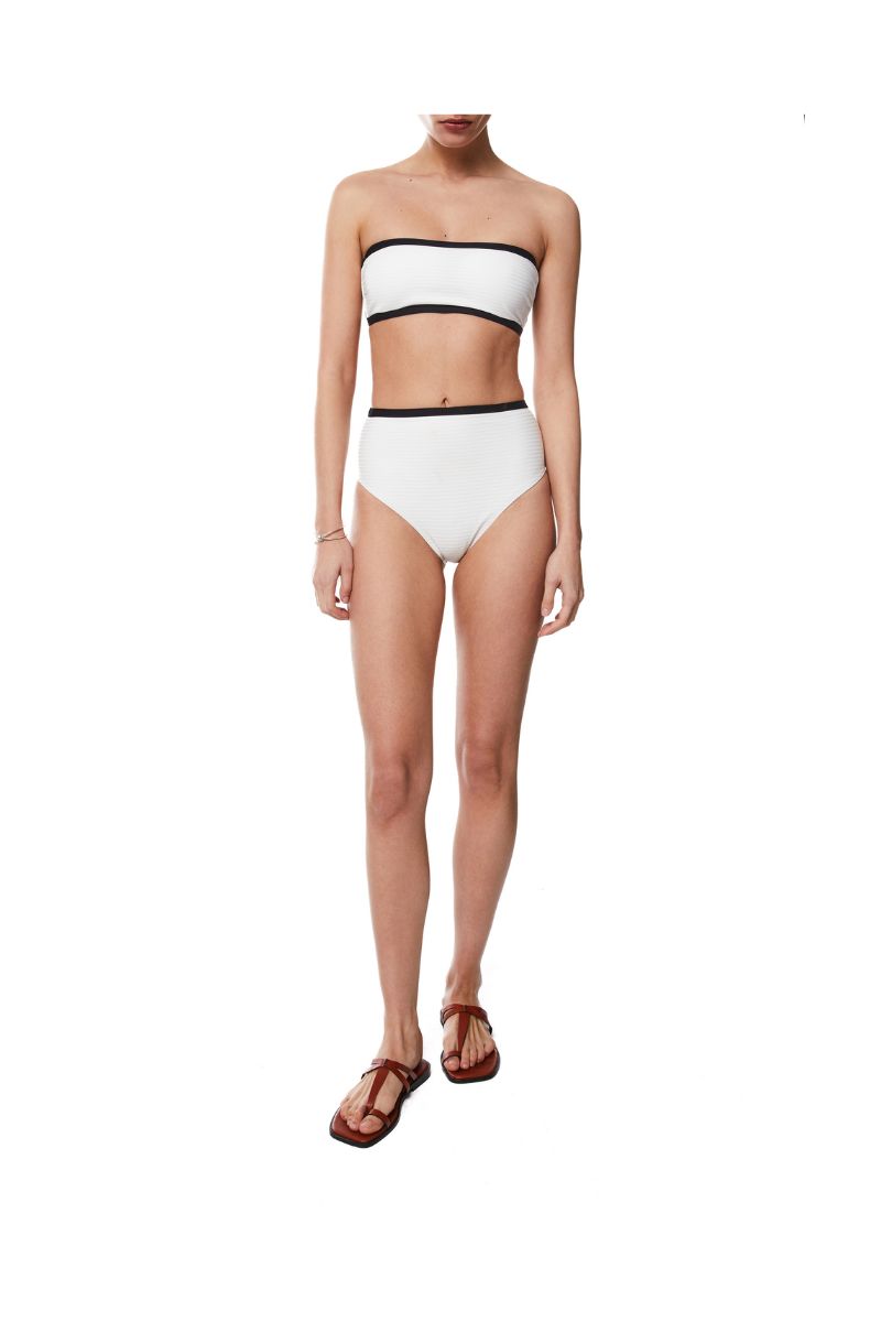 White bikini set featuring embossed June top and Cora bottom from KIÓHNE, showcasing textured fabric and stylish fit.