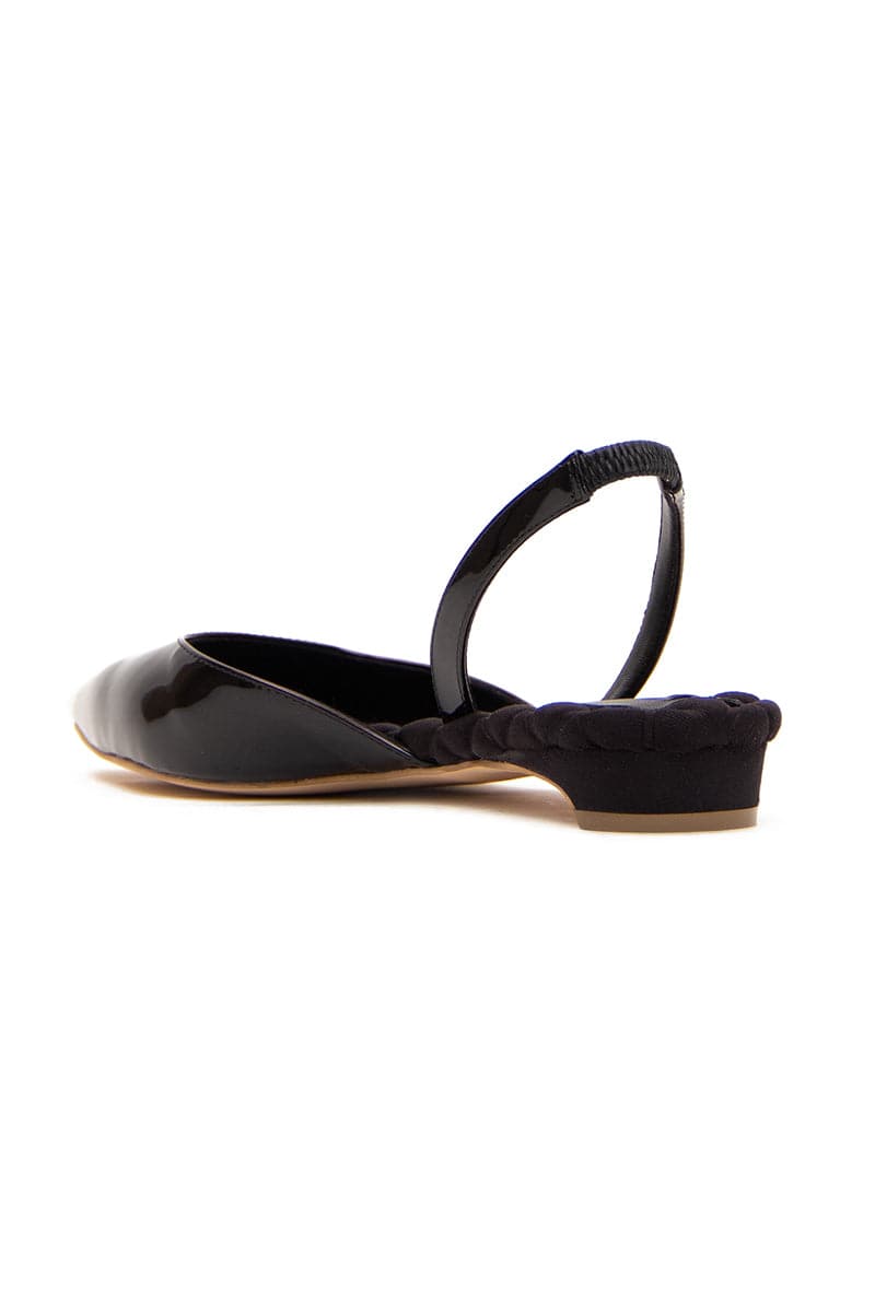 A pair of black patent-effect slingback flats from AERA with pointed toes and sleek design, shown on a plain background.