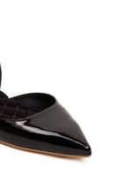 A pair of AERA Jackie black patent-effect slingback flats displayed from the front, showing sleek design and pointed toe.