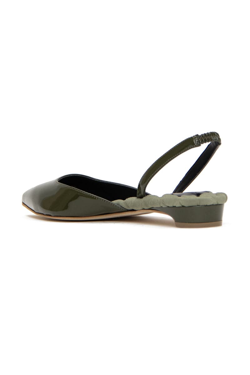 A pair of green patent-effect slingback flats by AERA, showing the stylish pointed toe and elegant design on a white background.