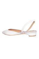 A pair of ivory patent-effect slingback flats from AERA, featuring a sleek and stylish design with a pointed toe.