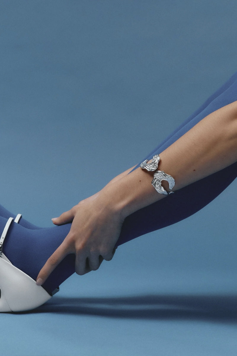Jude Benhalim Janus cuff bracelet in rhodium finish with sleek, modern design and smooth, reflective surface.