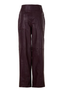 Japanese leather pants in wine red by MAZ Manuela Álvarez, showing sleek, fitted design with smooth leather texture.