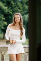 White Jenna dress by Nana Jacqueline, a stylish mini dress with a fitted silhouette and elegant design, shown in a campaign setting.