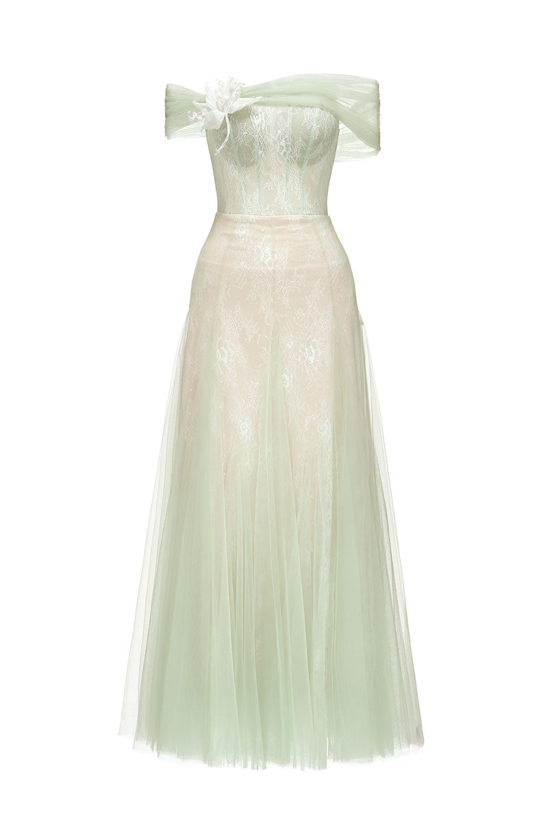 Green TINLEY gown by JOSÉPHINE, featuring elegant fabric and a flowing silhouette, displayed on a dress form.