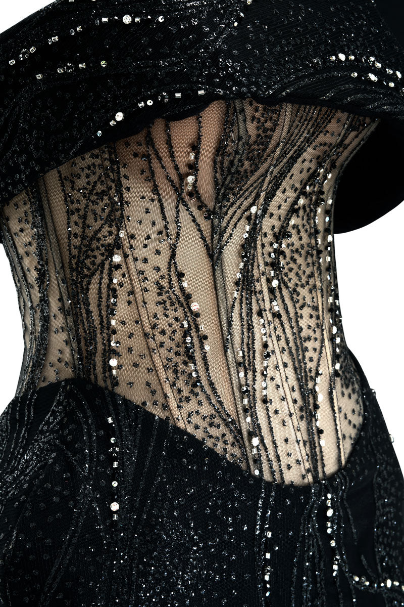 Black Natasha gown by JOSÉPHINE, featuring elegant fabric and a flowing silhouette, displayed on a mannequin.