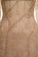 Beige JADALINE maxi dress by JOSÉPHINE, flowing fabric and elegant design, displayed on a hanger.