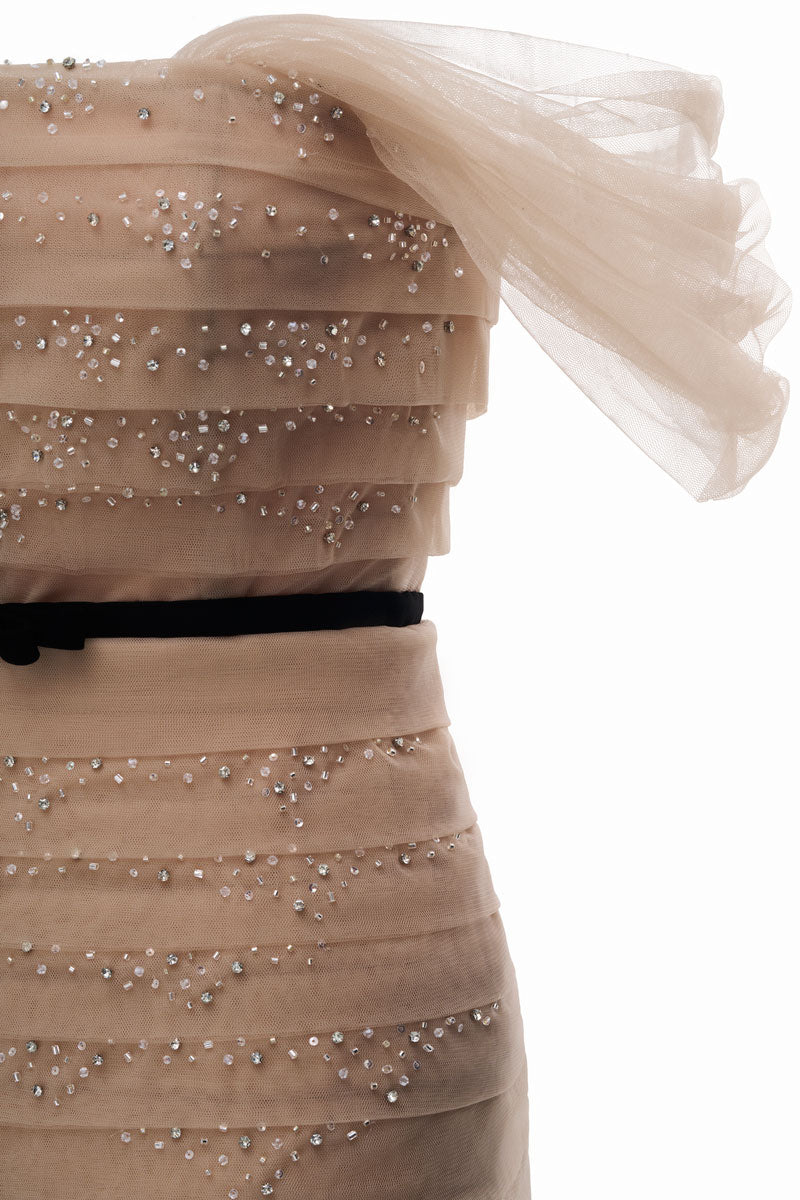 Beige ABIGAL maxi dress by JOSÉPHINE displayed on a hanger, showcasing its flowing fabric and elegant design.