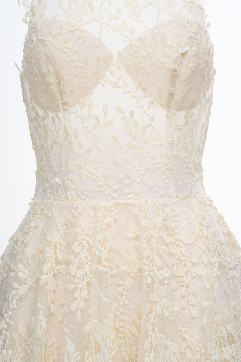 Cream Cynthia midi dress by JOSÉPHINE shown on a hanger, featuring a flowing silhouette and elegant design.