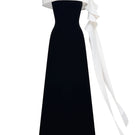Black Magnolia gown by JOSÉPHINE featuring elegant fabric and a flowing silhouette, perfect for formal occasions.