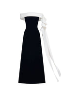Black Magnolia gown by JOSÉPHINE featuring elegant fabric and a flowing silhouette, perfect for formal occasions.