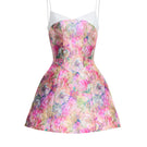 JOSÉPHINE RINA mini dress in flowy fabric with floral pattern, sleeveless design, and V-neck, perfect for summer wear.