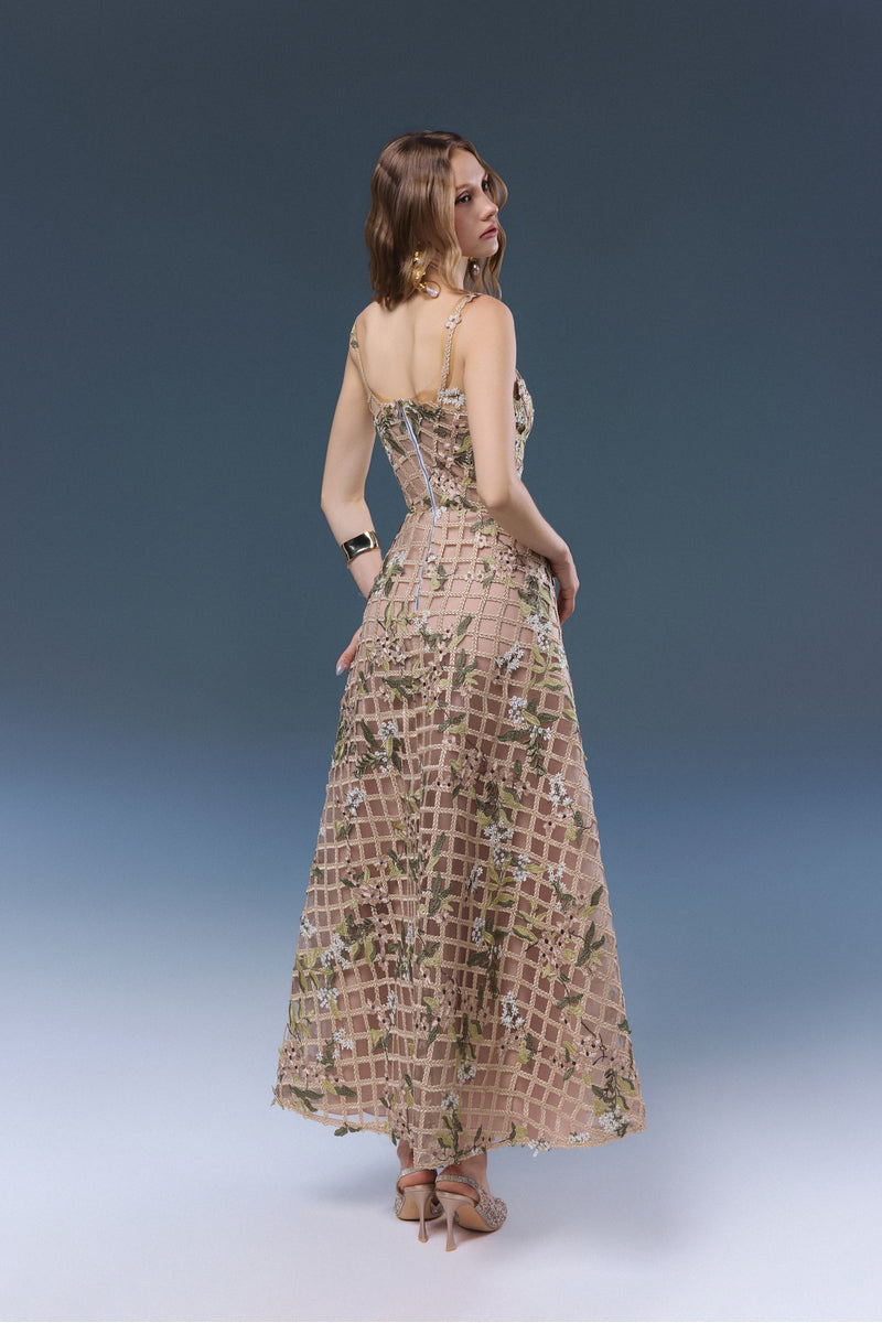 Beige Elsie midi dress by JOSÉPHINE, featuring a flowing silhouette and elegant design, shown on a model.