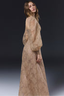 Beige JADOLINE maxi dress by JOSÉPHINE displayed on a hanger, showcasing its flowing fabric and elegant design.