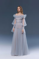 Elegant blue Aurora gown by JOSÉPHINE, featuring flowing fabric and stylish design, perfect for formal occasions.