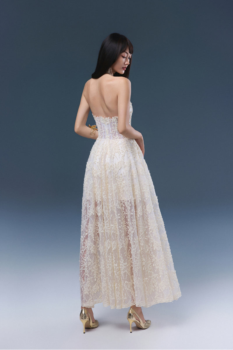 Cream Cynthia midi dress by JOSÉPHINE, featuring elegant fabric and a flowing silhouette, displayed on a hanger against a neutral background.