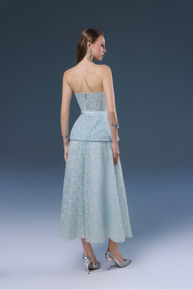 Blue Joséphine Kylie midi dress displayed on a hanger, showcasing its elegant fabric and stylish design.