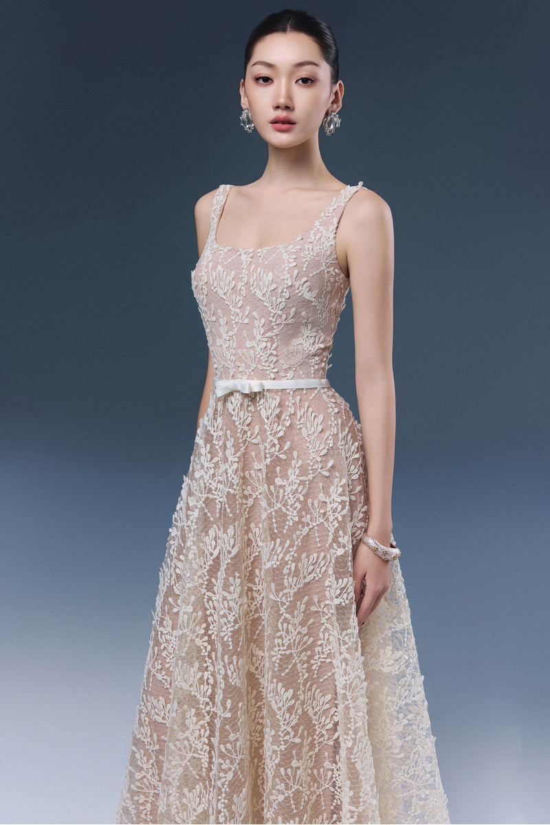 Elegant Josephine Rika lace midi dress displayed on a hanger, showcasing intricate lace details and flowing silhouette.
