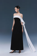 Black Magnolia gown by JOSÉPHINE featuring elegant fabric and a flowing silhouette, perfect for formal occasions.
