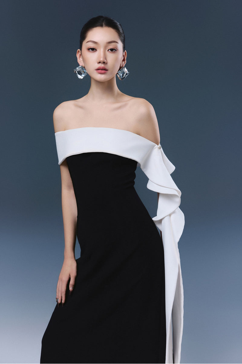Black Magnolia maxi dress by JOSÉPHINE featuring a flowing silhouette and elegant design, displayed on a hanger.